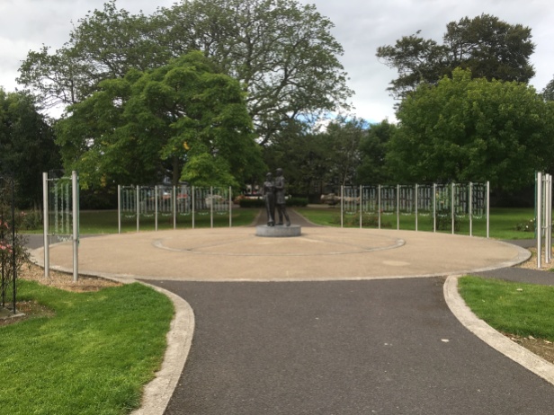 The Rose of Tralee sculpture surrounded by the glass Rose Wall of Honour